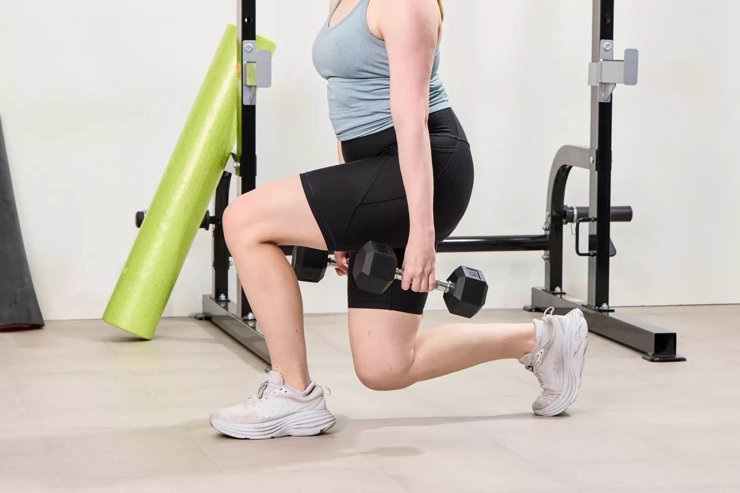 A person does squats using the Bells of Steel Ergo Rubber Hex Dumbbells