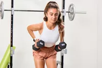 A person exercises using the CAP Barbell Neoprene Dumbbells