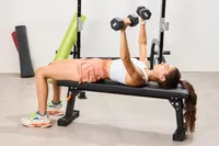 A person does chest presses using the CAP Barbell Neoprene Dumbbells