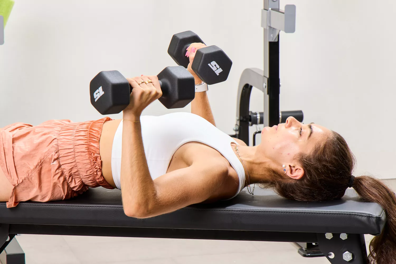 A person does chest presses using the CAP Barbell Neoprene Dumbbells