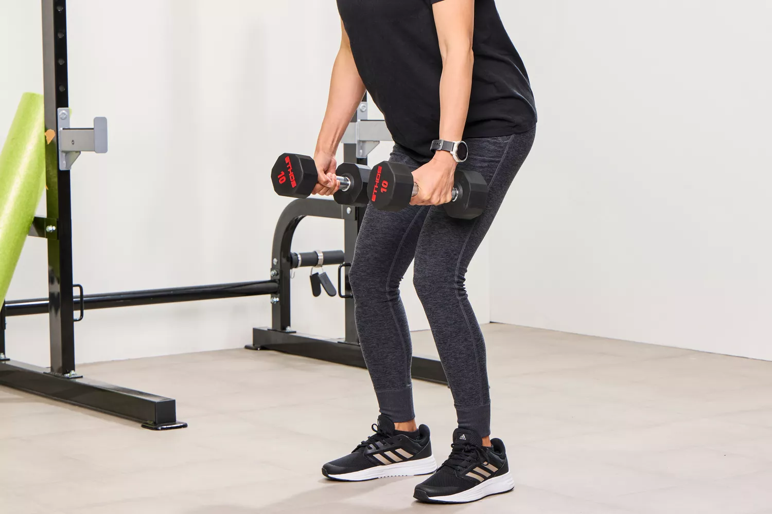 A person lifts the ETHOS Rubber Hex Dumbbells