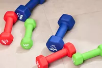 The different sizes and colors of the JFIT Dumbbell Set with Rack