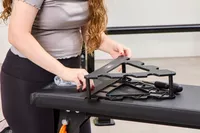 A person assembles the JFIT Dumbbell Set with Rack
