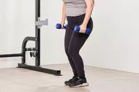 A person does curls while holding the JFIT Dumbbell Set with Rack