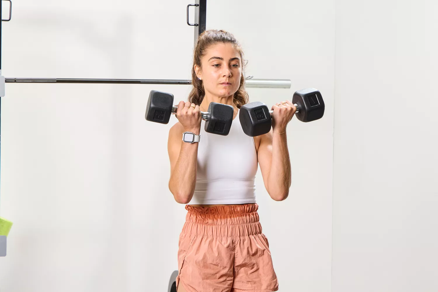 A person does arm curls using the Nike Dumbbells