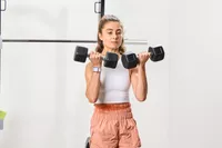 A person does arm curls using the Nike Dumbbells