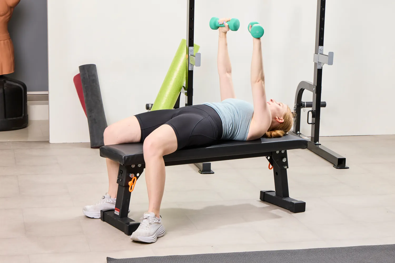 A person does chest presses with the Yes4All Neoprene Coated Dumbbells