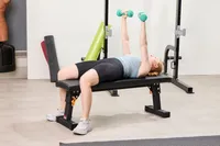 A person does chest presses with the Yes4All Neoprene Coated Dumbbells