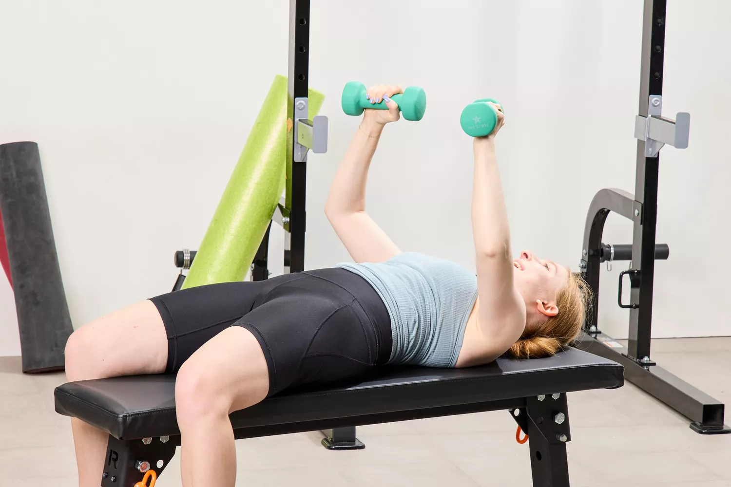 A person does chest presses using the Yes4All Neoprene Coated Dumbbells