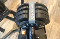 The brand logo on the Echelon Strength Adjustable Dumbbells 752 with Stand