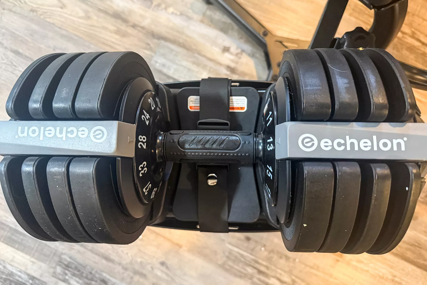 An overhead view of the Echelon Strength Adjustable Dumbbells 752 with Stand