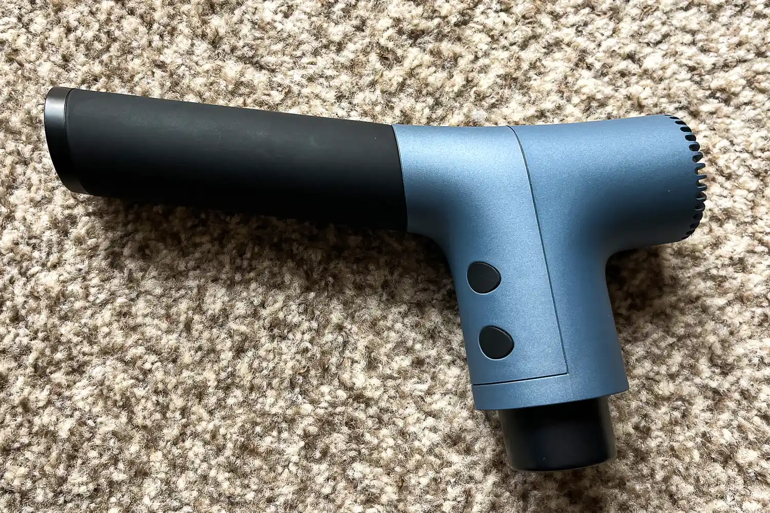 The Ekrin 365 Massage Gun on a rug