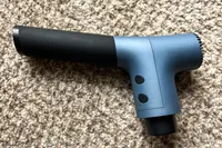 The Ekrin 365 Massage Gun on a rug