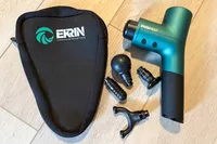 The Ekrin B37 Massage Gun with different attachment heads and a storage bag