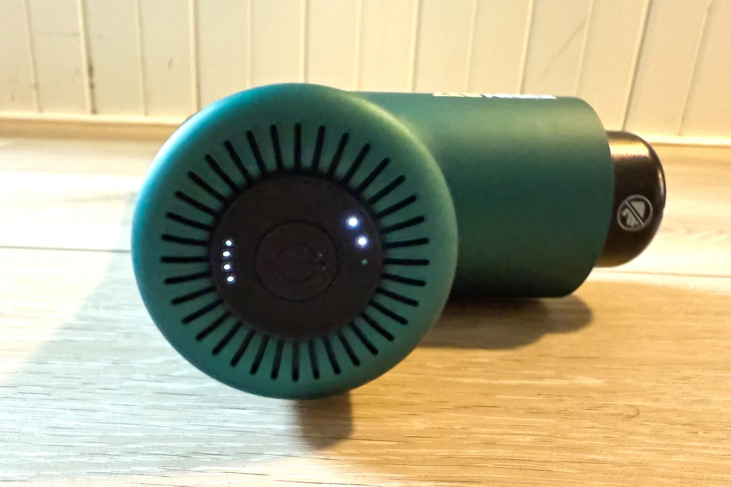 A close-up of the power button on the Ekrin B37 Massage Gun