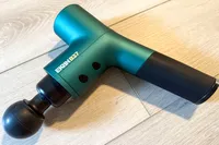 The Ekrin B37 Massage Gun on a tile floor