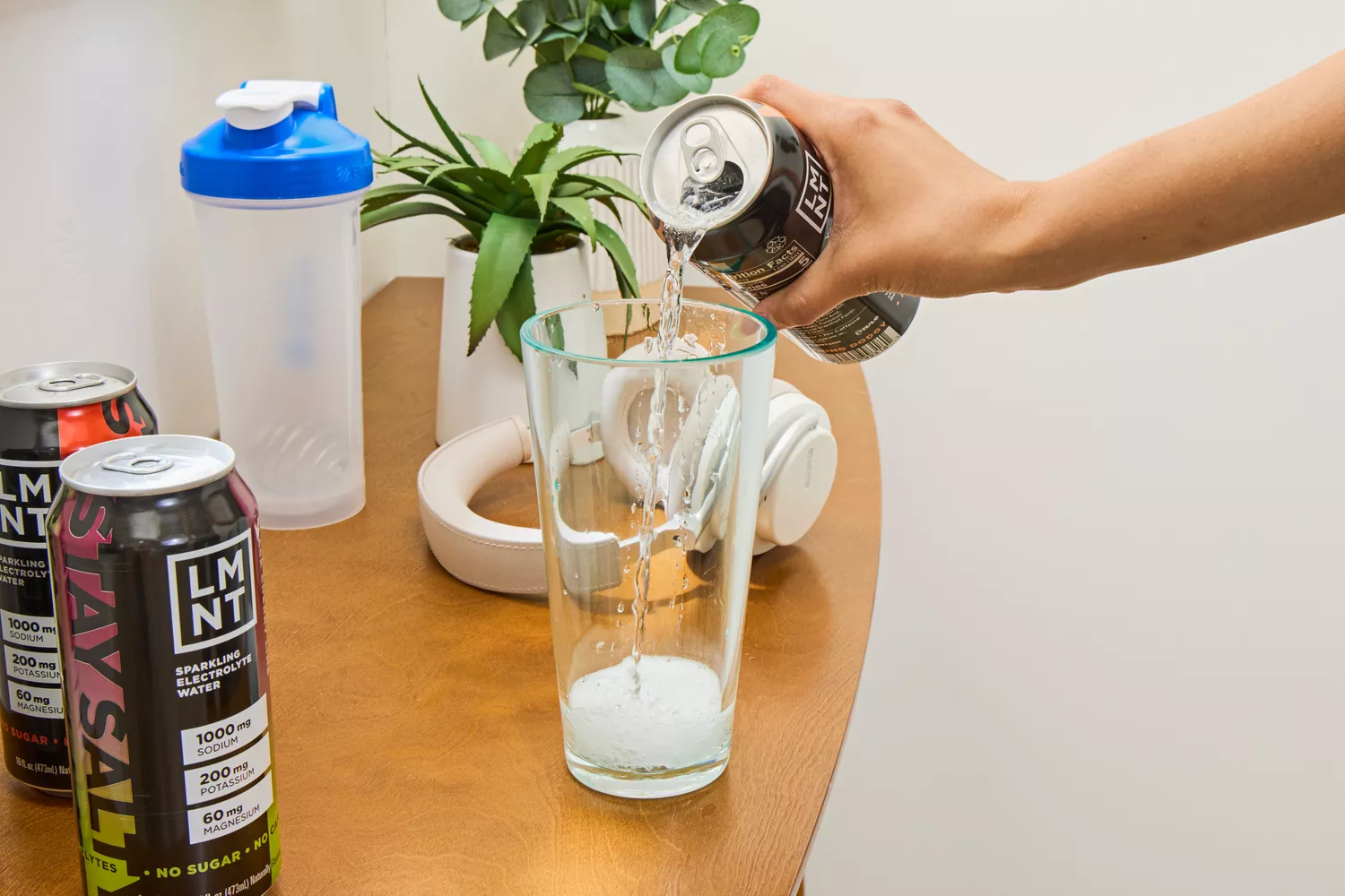 A person pours LMNT Sparkling Electrolyte Water into a glass