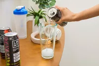 A person pours LMNT Sparkling Electrolyte Water into a glass