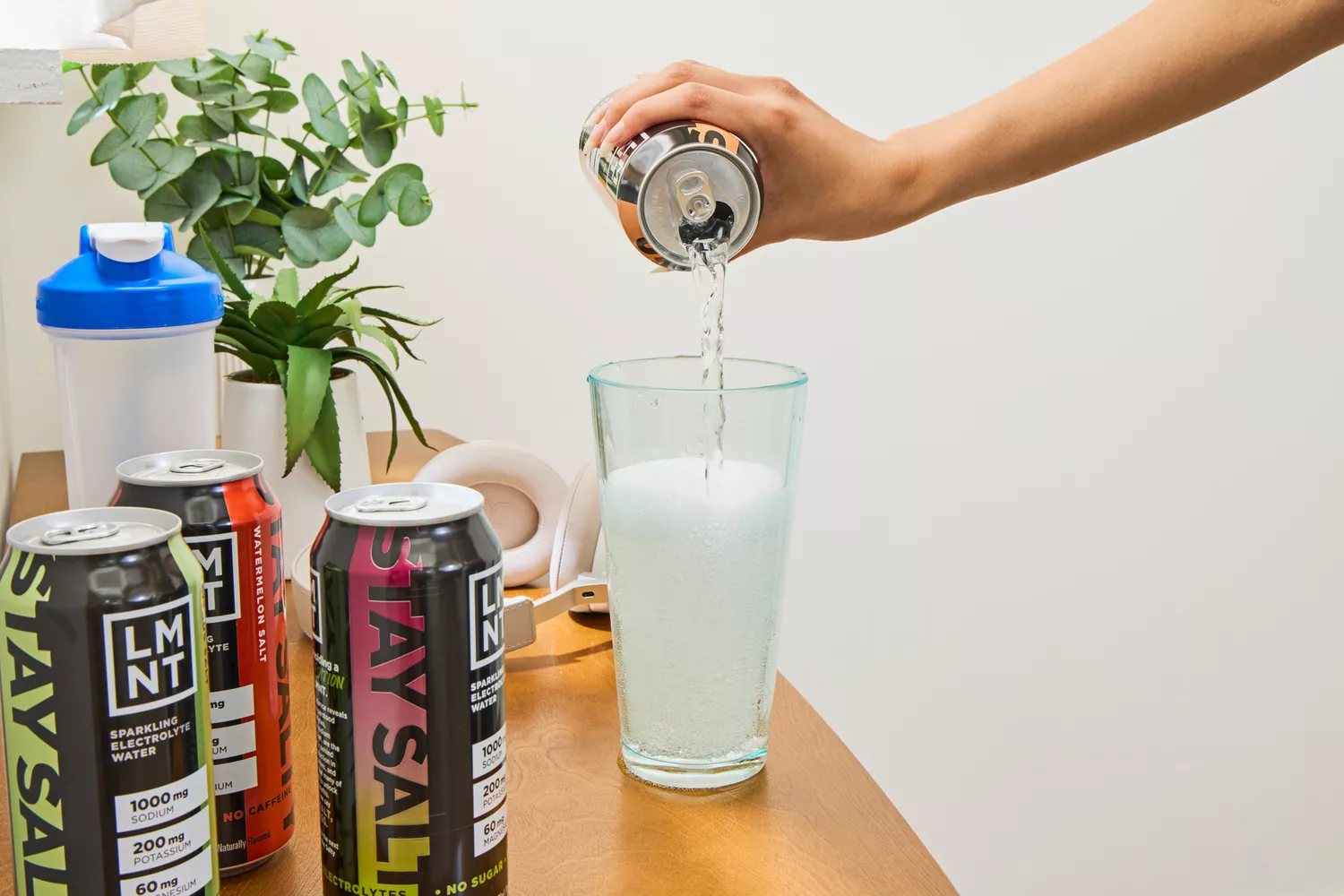 A person pours LMNT Sparkling Electrolyte Water into a glass
