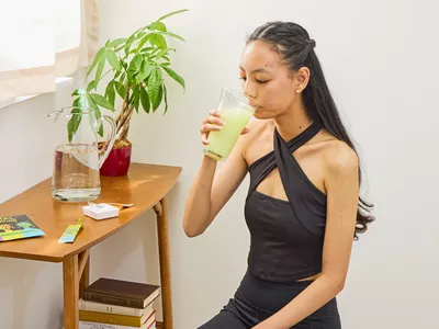 A person drinks a glass of Mortal Hydration Sport Drink Mix