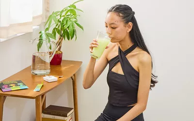A person drinks a glass of Mortal Hydration Sport Drink Mix