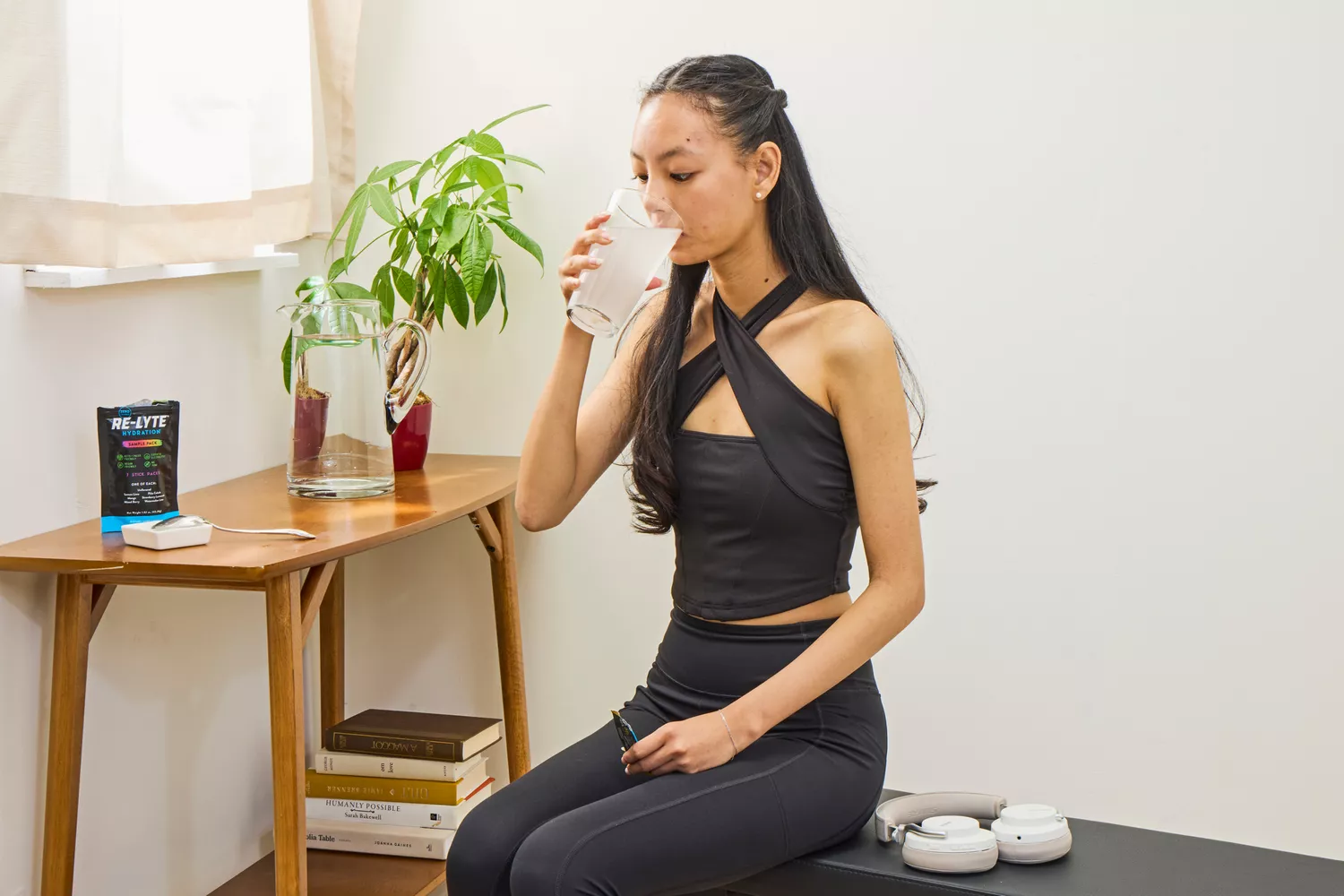 A person drinks a glass of REDMOND Re-Lyte Hydration Electrolyte Mix