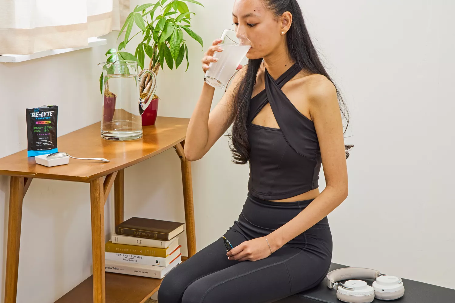 A person drinks a glass of REDMOND Re-Lyte Hydration Electrolyte Mix