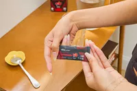 A person holds up a packet of Vega Sport Electrolyte Hydrator