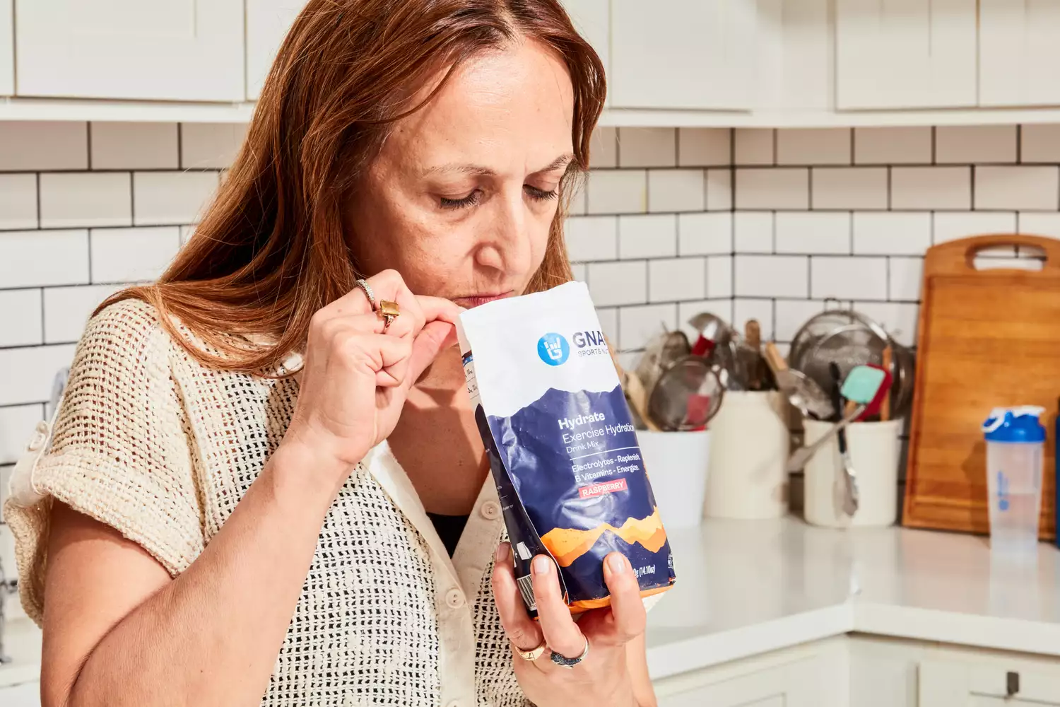 A person sniffing Gnarly Nutrition Hydrate Electrolyte Powder inside of the pouch