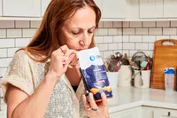 A person sniffing Gnarly Nutrition Hydrate Electrolyte Powder inside of the pouch