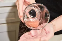 'Two hands tilting a glass to show the inside drink made with Hydrant Hydrate Hydration Drink Mix