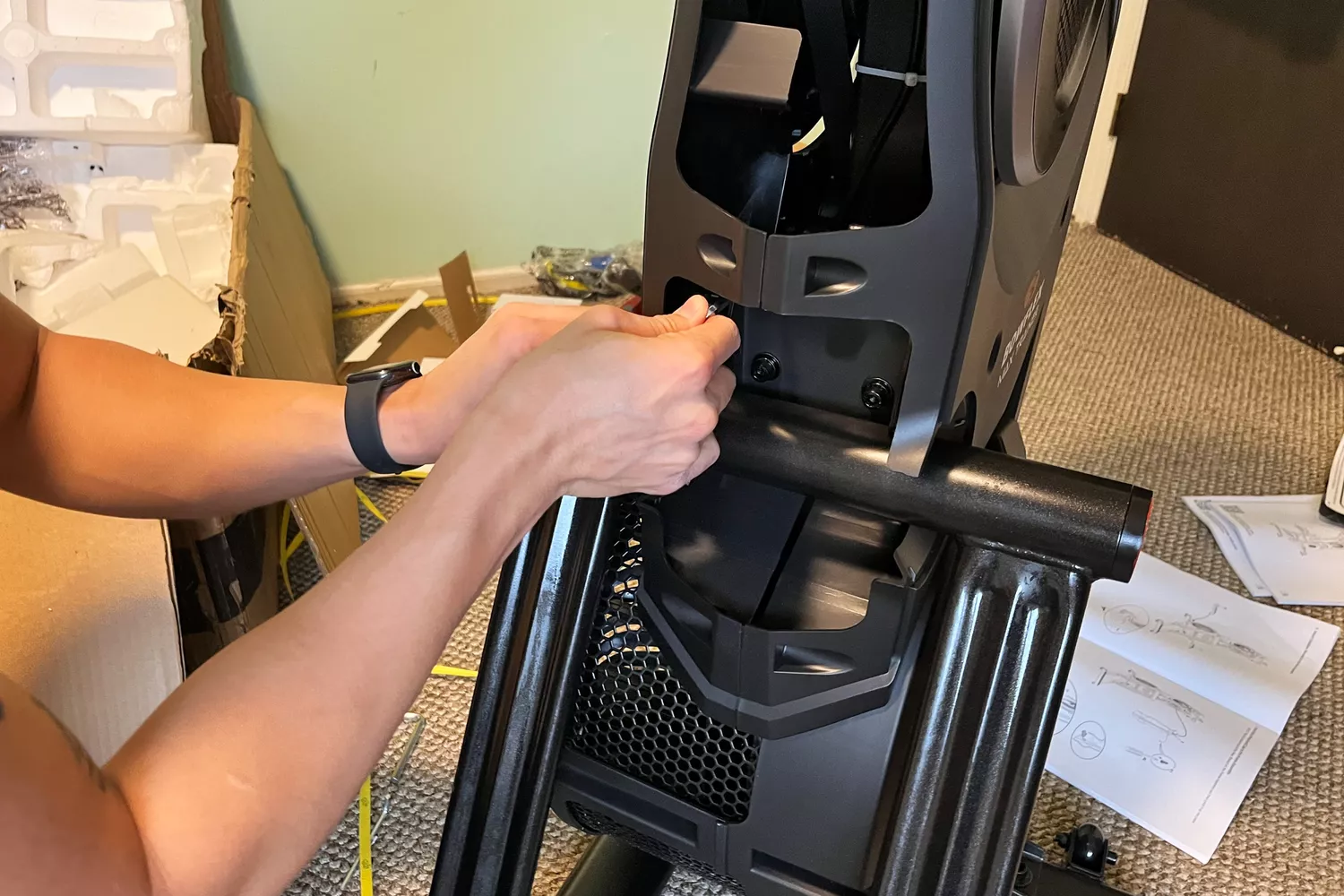 A person touching part of the BowFlex Max Total 16