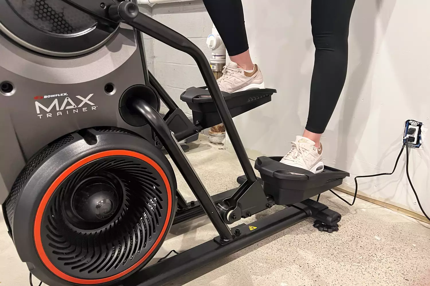 A close-up of a person's legs on the BowFlex Max Trainer M9