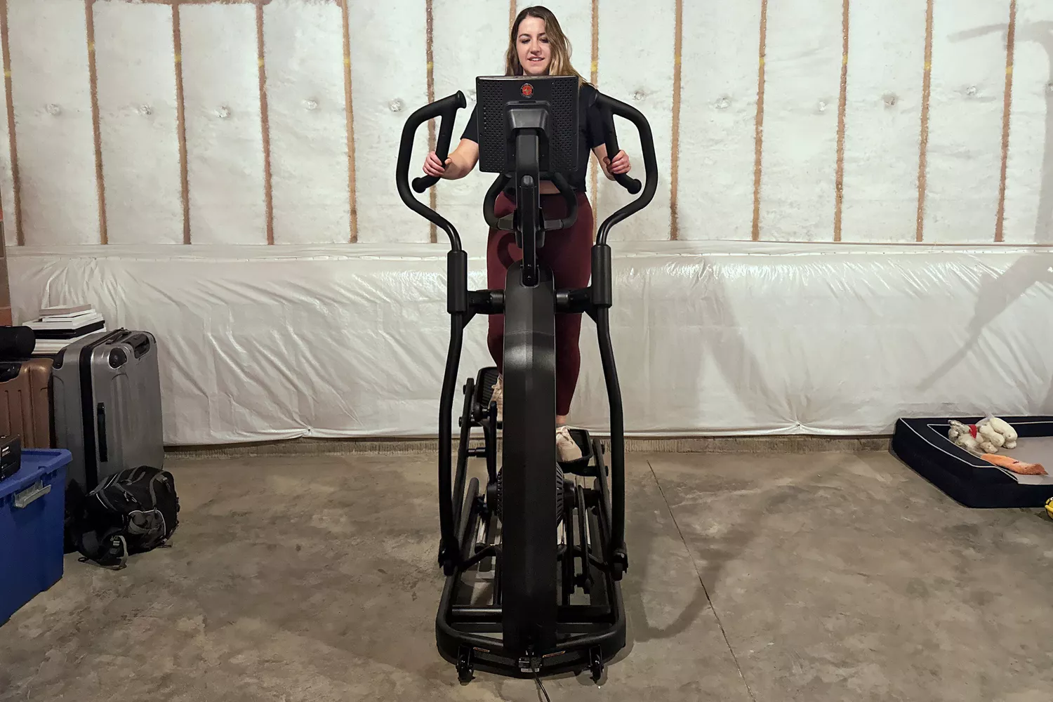 A person on the Schwinn 490 Elliptical near suitcases