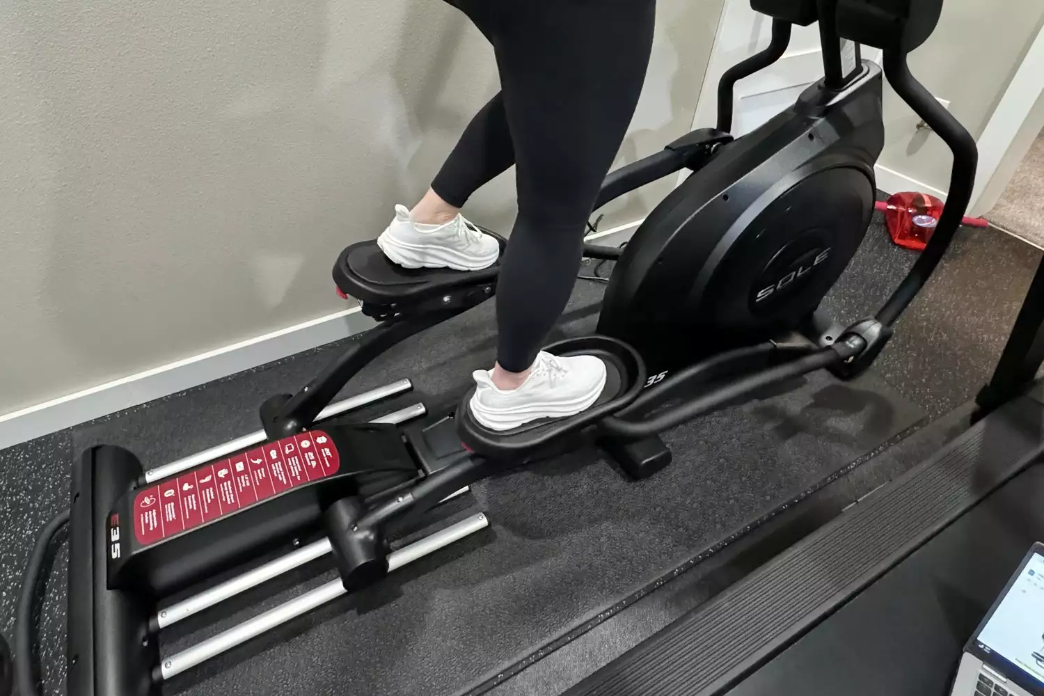 A close-up of the Sole E35 Elliptical with a person