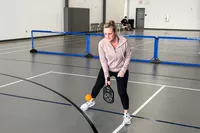 A person playing indoor pickleball with the Engage Pickleball Aero | Raw Toray T700