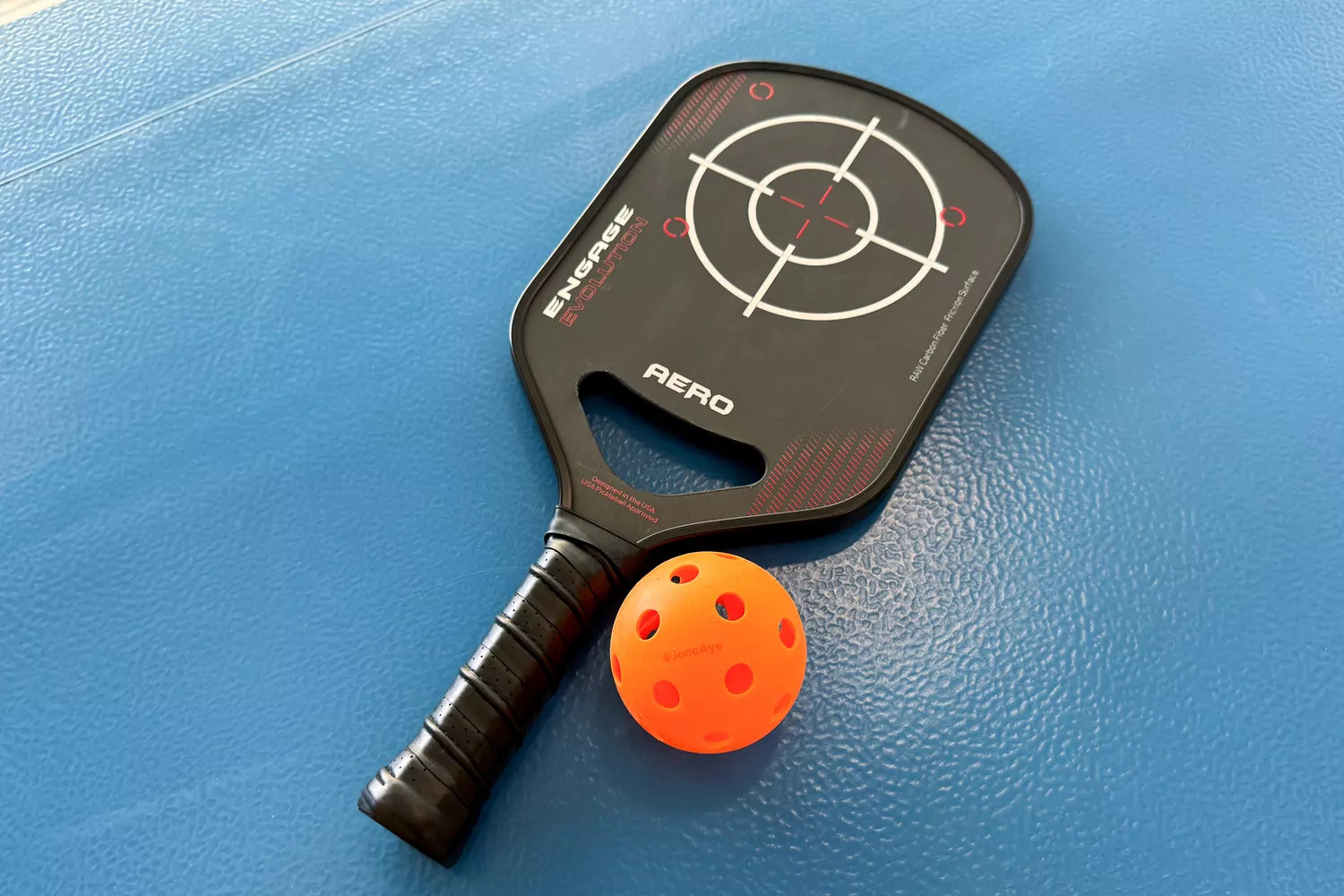 The Engage Pickleball Aero | Raw Toray T700 next to a ball