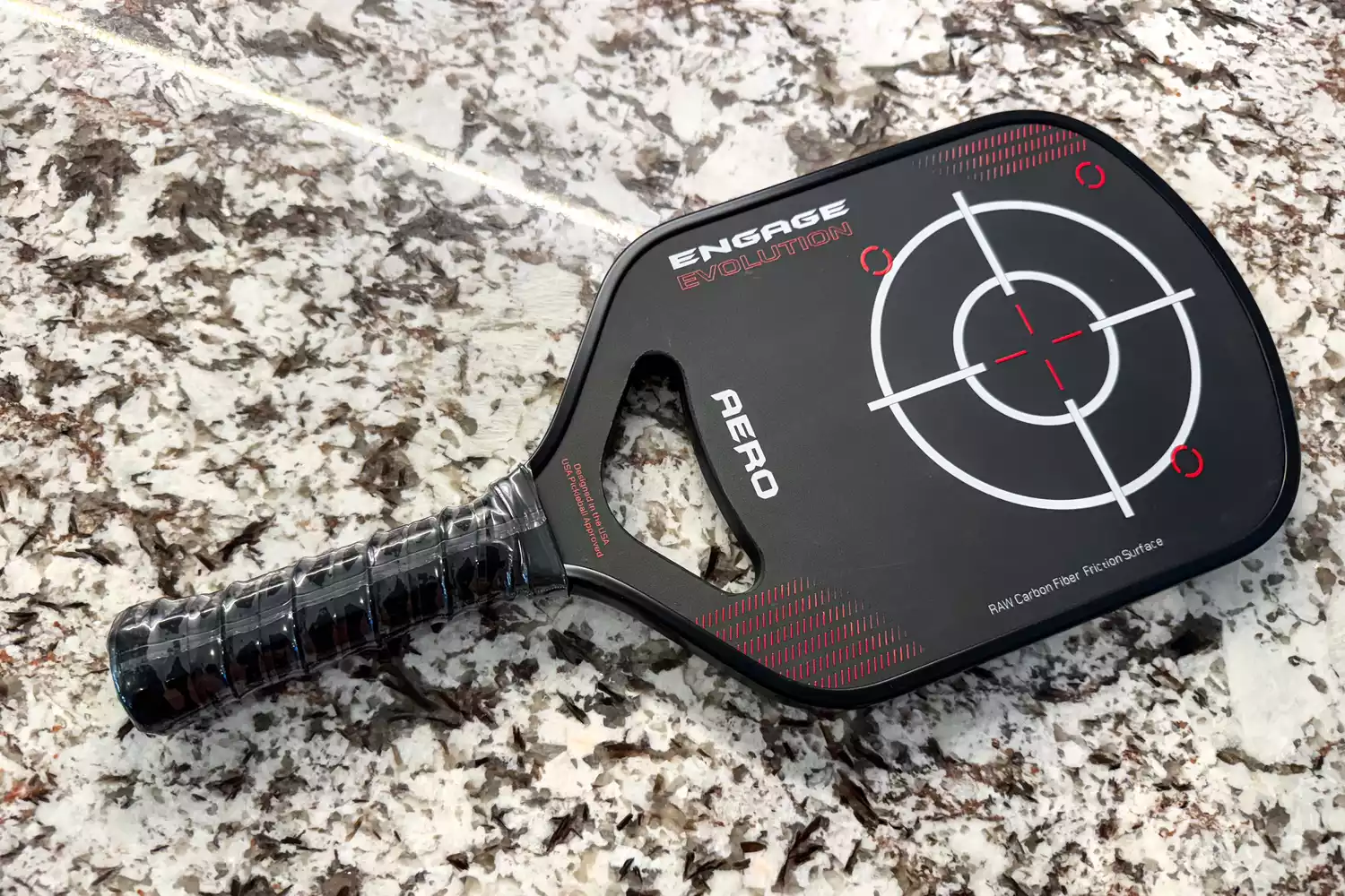 An overhead view of the Engage Pickleball Aero | Raw Toray T700 on a counter