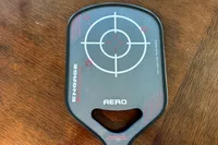 A close-up of the Engage Pickleball Aero | Raw Toray T700 on a wooden surface