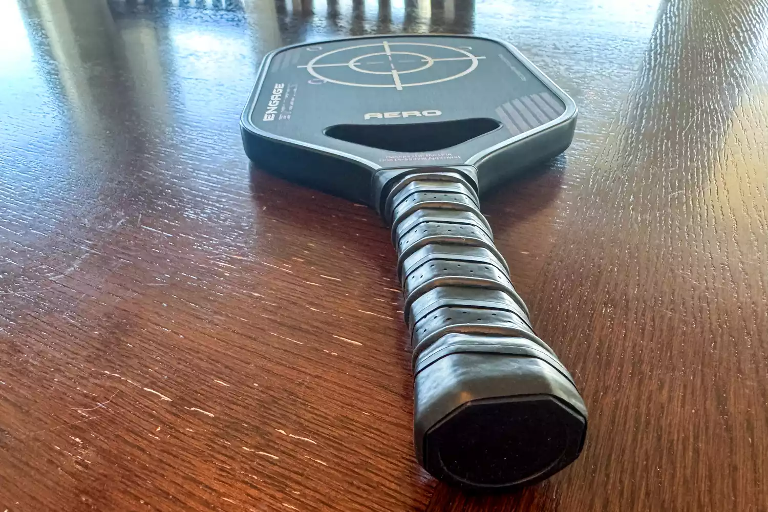 The Engage Pickleball Aero | Raw Toray T700 on a wooden surface