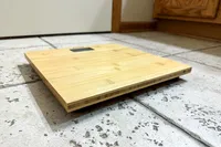 The Escali Bamboo Digital Electronic Bathroom Scale on a tile floor