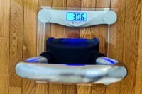 A weight sits on the Etekcity EB4074C Digital Body Weight Scale