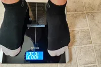 A person stands on the Etekcity ESF93 Smart Fitness Scale