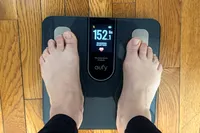 A person stands barefoot on the eufy Smart Scale C20