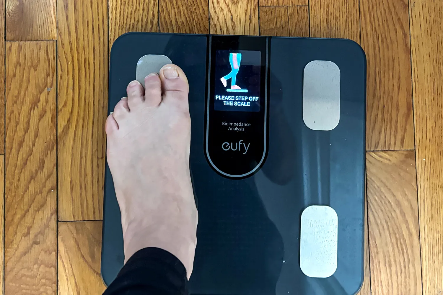 A person stands on one foot on the eufy Smart Scale C20