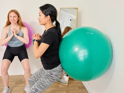 A person exercises using the Gaiam Total Body Balance Ball Kit