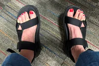 An overhead view of a person wearing the FitFlop Women's GEN-FF Adjustable Webbing/Leather Back-Strap Sandals