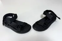 A pair of FitFlop Women's GEN-FF Adjustable Webbing/Leather Back-Strap Sandals on a white table