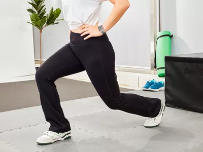 Person stretching while wearing Yogipace Bootcut Yoga Pants