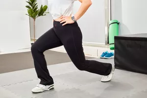 Person stretching while wearing Yogipace Bootcut Yoga Pants